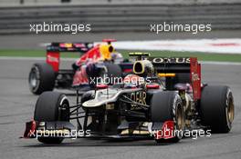 Romain Grosjean (FRA) Lotus F1 E20 leads Sebastian Vettel (GER) Red Bull Racing RB8. 15.04.2012. Formula 1 World Championship, Rd 3, Chinese Grand Prix, Shanghai, China, Race Day