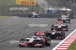 Jenson Button (GBR) McLaren MP4/27 leads Kimi Raikkonen (FIN) Lotus E20. 15.04.2012. Formula 1 World Championship, Rd 3, Chinese Grand Prix, Shanghai, China, Race Day