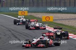 Jenson Button (GBR) McLaren MP4/27 leads Kimi Raikkonen (FIN) Lotus E20. 15.04.2012. Formula 1 World Championship, Rd 3, Chinese Grand Prix, Shanghai, China, Race Day