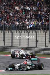 Michael Schumacher (GER) Mercedes AMG F1 W03 leads Kamui Kobayashi (JPN) Sauber C31. 15.04.2012. Formula 1 World Championship, Rd 3, Chinese Grand Prix, Shanghai, China, Race Day