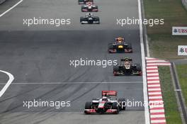 Jenson Button (GBR) McLaren MP4/27 leads Romain Grosjean (FRA) Lotus F1 E20. 15.04.2012. Formula 1 World Championship, Rd 3, Chinese Grand Prix, Shanghai, China, Race Day