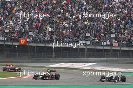 Sergio Perez (MEX) Sauber C31 is passed by Romain Grosjean (FRA) Lotus F1 E20. 15.04.2012. Formula 1 World Championship, Rd 3, Chinese Grand Prix, Shanghai, China, Race Day