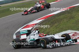 Michael Schumacher (GER) Mercedes AMG F1 W03 leads Jenson Button (GBR) McLaren MP4/27. 15.04.2012. Formula 1 World Championship, Rd 3, Chinese Grand Prix, Shanghai, China, Race Day