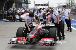 McLaren MP4/27 of Jenson Button (GBR) McLaren pushed from scrutineering by mechanics. 14.04.2012. Formula 1 World Championship, Rd 3, Chinese Grand Prix, Shanghai, China, Qualifying Day