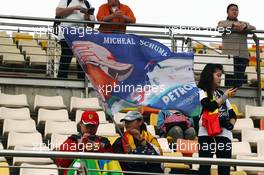 Michael Schumacher (GER) Mercedes AMG F1 W03 banner and fans.