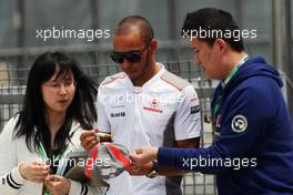 Lewis Hamilton (GBR) McLaren signs autographs for the fans. 15.04.2012. Formula 1 World Championship, Rd 3, Chinese Grand Prix, Shanghai, China, Race Day