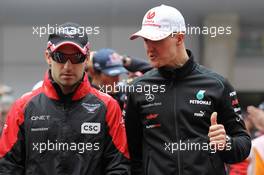 (L to R): Timo Glock (GER) Marussia F1 Team with Michael Schumacher (GER) Mercedes AMG F1 on the drivers parade. 15.04.2012. Formula 1 World Championship, Rd 3, Chinese Grand Prix, Shanghai, China, Race Day