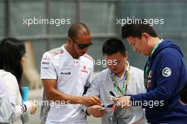 Lewis Hamilton (GBR) McLaren signs autographs for the fans. 15.04.2012. Formula 1 World Championship, Rd 3, Chinese Grand Prix, Shanghai, China, Race Day