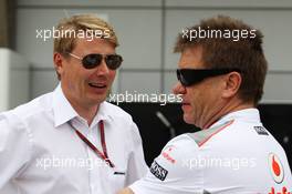 (L to R): Mika Hakkinen (FIN) talks with Dr. Aki Hintsa (FIN) McLaren Team Doctor. 15.04.2012. Formula 1 World Championship, Rd 3, Chinese Grand Prix, Shanghai, China, Race Day
