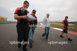 Charles Pic (FRA) Marussia F1 Team walks the circuit with Olivier Panis (FRA) (Right). 12.04.2012. Formula 1 World Championship, Rd 3, Chinese Grand Prix, Shanghai, China, Preparation Day
