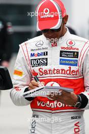 Lewis Hamilton (GBR) McLaren signs autographs for the fans. 12.04.2012. Formula 1 World Championship, Rd 3, Chinese Grand Prix, Shanghai, China, Preparation Day