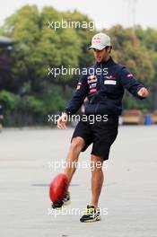Daniel Ricciardo (AUS) Scuderia Toro Rosso plays Australian Rules Football in the paddock. 12.04.2012. Formula 1 World Championship, Rd 3, Chinese Grand Prix, Shanghai, China, Preparation Day