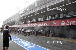 Members of all teams come to the aid of Williams as their garage catches fire after the race. 10.05.2012. Formula 1 World Championship, Rd 5, Spanish Grand Prix, Barcelona, Spain, Race Day