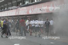 A fire in the Williams pit garage after the celebrations is tended to by members of all F1 teams. 10.05.2012. Formula 1 World Championship, Rd 5, Spanish Grand Prix, Barcelona, Spain, Race Day