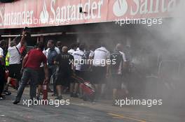 A fire in the Williams pit garage after the celebrations is tended to by members of all F1 teams. 10.05.2012. Formula 1 World Championship, Rd 5, Spanish Grand Prix, Barcelona, Spain, Race Day