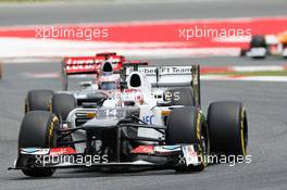 Kamui Kobayashi (JPN) Sauber C31 leads Jenson Button (GBR) McLaren MP4/27. 10.05.2012. Formula 1 World Championship, Rd 5, Spanish Grand Prix, Barcelona, Spain, Race Day