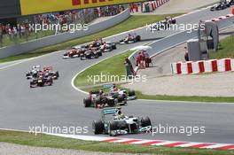 Nico Rosberg (GER) Mercedes AMG F1 W03 leads a battling Romain Grosjean (FRA) Lotus F1 E20 and Michael Schumacher (GER) Mercedes AMG F1 W03 at the start of the race. 10.05.2012. Formula 1 World Championship, Rd 5, Spanish Grand Prix, Barcelona, Spain, Race Day