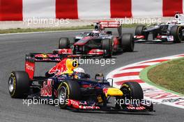 Sebastian Vettel (GER) Red Bull Racing RB8 leads Jenson Button (GBR) McLaren MP4/27 and Kamui Kobayashi (JPN) Sauber C31. 10.05.2012. Formula 1 World Championship, Rd 5, Spanish Grand Prix, Barcelona, Spain, Race Day