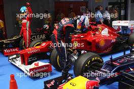 Sebastian Vettel (GER) cools the brakes on his Red Bull Racing RB8 in parc ferme as Fernando Alonso (ESP) Ferrari celebrates his third position. 12.05.2012. Formula 1 World Championship, Rd 5, Spanish Grand Prix, Barcelona, Spain, Qualifying Day