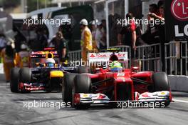 Felipe Massa (BRA) Ferrari F2012 and Sebastian Vettel (GER) Red Bull Racing RB8 leave the pits. 12.05.2012. Formula 1 World Championship, Rd 5, Spanish Grand Prix, Barcelona, Spain, Qualifying Day