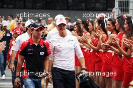 (L to R): Timo Glock (GER) Marussia F1 Team with Michael Schumacher (GER) Mercedes AMG F1 on the drivers parade. 10.05.2012. Formula 1 World Championship, Rd 5, Spanish Grand Prix, Barcelona, Spain, Race Day