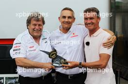 (L to R):Norbert Haug (GER) Mercedes Sporting Director, Martin Whitmarsh (GBR) McLaren Chief Executive Officer and David Coulthard (GBR) Red Bull Racing and Scuderia Toro Advisor / BBC Television Commentator with wheel nuts from the winning McLaren cars of David Coulthard (GBR) in 1997 and Lewis Hamilton (GBR) McLaren in 2012. 22.06.2012. Formula 1 World Championship, Rd 8, European Grand Prix, Valencia, Spain, Practice Day