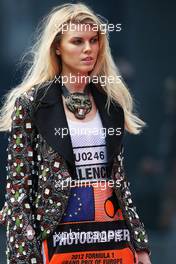 A glamorous woman wearing a photographer's tabard. 22.06.2012. Formula 1 World Championship, Rd 8, European Grand Prix, Valencia, Spain, Practice Day