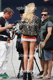 A glamorous woman wearing a photographer's tabard. 22.06.2012. Formula 1 World Championship, Rd 8, European Grand Prix, Valencia, Spain, Practice Day