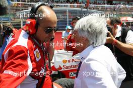 Bernie Ecclestone (GBR) CEO Formula One Group (FOM) with Luca Colajanni (ITA) Ferrari Press Officer on the grid. 24.06.2012. Formula 1 World Championship, Rd 8, European Grand Prix, Valencia, Spain, Race Day