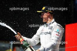 Michael Schumacher (GER) Mercedes AMG F1 celebrates his third position on the podium. 24.06.2012. Formula 1 World Championship, Rd 8, European Grand Prix, Valencia, Spain, Race Day