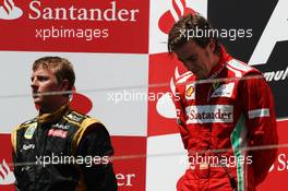 Race winner Fernando Alonso (ESP) Ferrari on the podium with wt placed Kimi Raikkonen (FIN) Lotus F1 Team (Left). 24.06.2012. Formula 1 World Championship, Rd 8, European Grand Prix, Valencia, Spain, Race Day