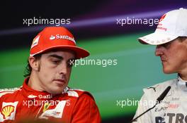 (L to R): Race winner Fernando Alonso (ESP) Ferrari and Michael Schumacher (GER) Mercedes AMG F1 in the post race FIA Press Conference. 24.06.2012. Formula 1 World Championship, Rd 8, European Grand Prix, Valencia, Spain, Race Day