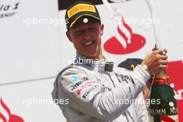 Michael Schumacher (GER) Mercedes AMG F1 celebrates his third position on the podium. 24.06.2012. Formula 1 World Championship, Rd 8, European Grand Prix, Valencia, Spain, Race Day