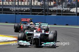 Michael Schumacher (GER) Mercedes AMG F1 W03 leads Lewis Hamilton (GBR) McLaren MP4/27 with front wing sparking. 24.06.2012. Formula 1 World Championship, Rd 8, European Grand Prix, Valencia, Spain, Race Day