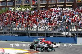 Michael Schumacher (GER) Mercedes AMG F1 W03 leads Fernando Alonso (ESP) Ferrari F2012. 24.06.2012. Formula 1 World Championship, Rd 8, European Grand Prix, Valencia, Spain, Race Day