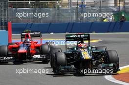 Heikki Kovalainen (FIN) Caterham CT01 leads Charles Pic (FRA) Marussia F1 Team MR01. 24.06.2012. Formula 1 World Championship, Rd 8, European Grand Prix, Valencia, Spain, Race Day