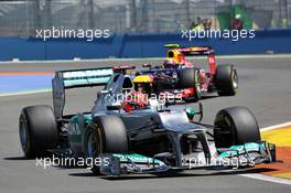 Michael Schumacher (GER) Mercedes AMG F1 W03 leads Mark Webber (AUS) Red Bull Racing RB8. 24.06.2012. Formula 1 World Championship, Rd 8, European Grand Prix, Valencia, Spain, Race Day