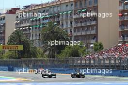 Michael Schumacher (GER) Mercedes AMG F1 W03 passes Vitaly Petrov (RUS) Caterham CT01. 24.06.2012. Formula 1 World Championship, Rd 8, European Grand Prix, Valencia, Spain, Race Day