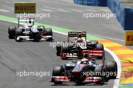 Lewis Hamilton (GBR) McLaren MP4/27 leads Romain Grosjean (FRA) Lotus F1 E20 and Kamui Kobayashi (JPN) Sauber C31. 24.06.2012. Formula 1 World Championship, Rd 8, European Grand Prix, Valencia, Spain, Race Day