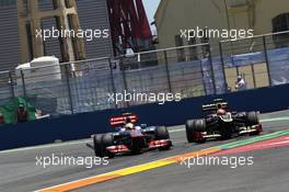 Lewis Hamilton (GBR) McLaren MP4/27 and Romain Grosjean (FRA) Lotus F1 E20 battle for position. 24.06.2012. Formula 1 World Championship, Rd 8, European Grand Prix, Valencia, Spain, Race Day