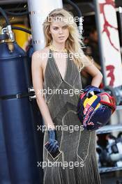 A glamorous woman with a Red Bull Racing mechanic's helmet. 23.06.2012. Formula 1 World Championship, Rd 8, European Grand Prix, Valencia, Spain, Qualifying Day