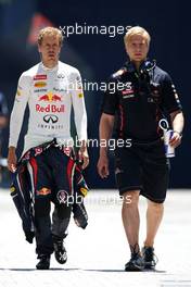 (L to R): Sebastian Vettel (GER) Red Bull Racing with Heikki Huovinen (FIN) Personal Trainer. 23.06.2012. Formula 1 World Championship, Rd 8, European Grand Prix, Valencia, Spain, Qualifying Day