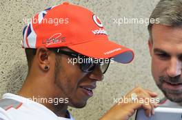 Lewis Hamilton (GBR) McLaren shows Adam Cooper (GBR) McLaren Press Officer a photo from his camera phone. 21.06.2012. Formula 1 World Championship, Rd 8, European Grand Prix, Valencia, Spain, Preparation Day