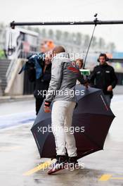 Lewis Hamilton (GBR) McLaren loses control of his umbrella in the pits. 06.07.2012. Formula 1 World Championship, Rd 9, British Grand Prix, Silverstone, England, Practice Day