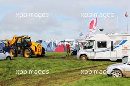 Wet and muddy car parks and camp sites at the circuit as a tractor helps remove a camper van. 06.07.2012. Formula 1 World Championship, Rd 9, British Grand Prix, Silverstone, England, Practice Day