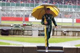 Vitaly Petrov (RUS) Caterham under the umbrella at the pit gantry. 06.07.2012. Formula 1 World Championship, Rd 9, British Grand Prix, Silverstone, England, Practice Day