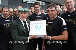 Jackie Stewart (GBR) supports the Grand Prix Mechanics Charitable Trust 25 Year Anniversary with the Hispania Racing F1 Team (HRT) team. 05.07.2012. Formula 1 World Championship, Rd 9, British Grand Prix, Silverstone, England, Preparation Day