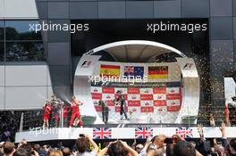 (L to R): Race winner Mark Webber (AUS) Red Bull Racing; Fernando Alonso (ESP) Ferrari and Sebastian Vettel (GER) Red Bull Racing celebrate on the podium. 08.07.2012. Formula 1 World Championship, Rd 9, British Grand Prix, Silverstone, England, Race Day
