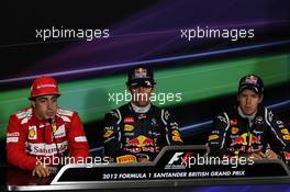 (L to R): Fernando Alonso (ESP) Ferrari; race winner Mark Webber (AUS) Red Bull Racing and Sebastian Vettel (GER) Red Bull Racing in the FIA Press Conference. 08.07.2012. Formula 1 World Championship, Rd 9, British Grand Prix, Silverstone, England, Race Day