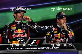 (L to R): Race winner Mark Webber (AUS) Red Bull Racing and Sebastian Vettel (GER) Red Bull Racing in the FIA Press Conference. 08.07.2012. Formula 1 World Championship, Rd 9, British Grand Prix, Silverstone, England, Race Day